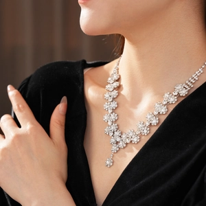 Macro detail of sunflower pendant necklace with sparkling diamonds on a model