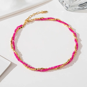 Double-layered necklace with pink natural stones and gold beads on a white background