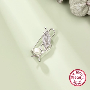 925 sterling silver leaf brooch with pearl and zircon accents on a soft green background