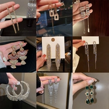 Detailed grid showing gold and silver tassel, geometric, and hoop earrings with zircon