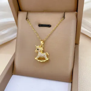 Detailed macro view of 18K gold rocking horse pendant with white zircon micro-pave setting
