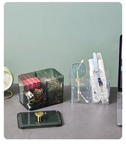 Close-up of divided acrylic desk organizers with golden heart handle and clear compartments