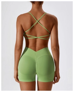 Detail of cross back sports bra and high waist scrunch butt yoga shorts in light green