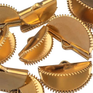 Macro shot of golden serrated semi-circle ribbon crimps for DIY jewelry making