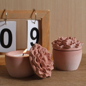 Pink peony flower scented candle jars with lotus lids on a cozy wooden desk display