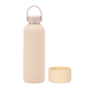 Detail of a beige insulated stainless steel bottle with portable handle and silicone base