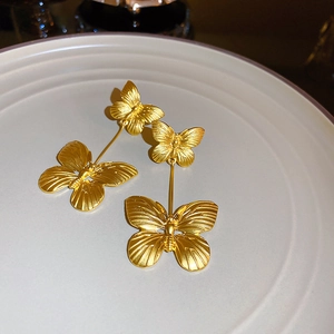 Elegant French vintage golden butterfly drop earrings with matte finish and textured details