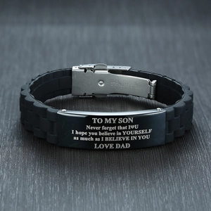 Detail of laser engraved 'TO MY SON' message on curved stainless steel silicone bracelet