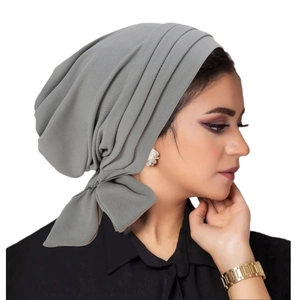 Grey velvet turban hat with a side bow design for women on a clean white background