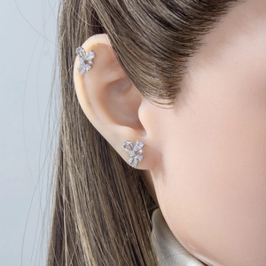 Elegant silver bow stud earrings with sparkling cubic zirconia on a female model
