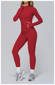 Detail of red brushed knit yoga set featuring a stand-collar zip jacket and high-waist pants
