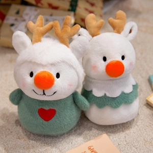 Adorable Christmas reindeer plush dolls with brown antlers and green holiday outfits