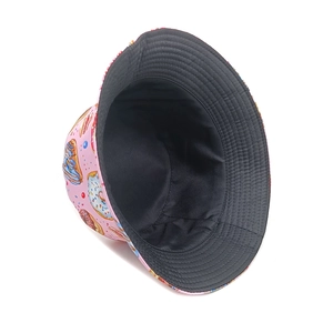 Detail of double-sided bucket hat with pink donut print and black inner lining fabric