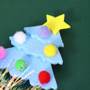 Macro detail of Christmas tree felt headband with colorful pom poms and tinsel fringe