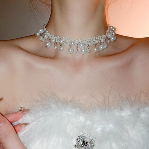 Detail of French vintage layered pearl necklace with elegant tassel pendant drops