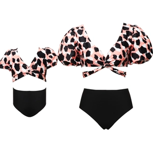 Detail of matching parent-child bikini set featuring leopard print tops and black bottoms