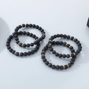 Unisex four-piece black onyx and lava stone beaded bracelet set with metallic spacers