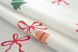 Close-up of waterproof polyester tablecloth with festive Christmas bells and tree patterns