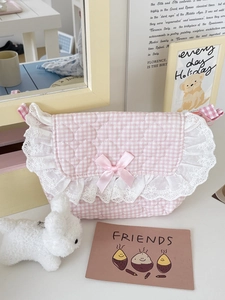 Detailed view of pink plaid crossbody bag with delicate lace edges and satin bow
