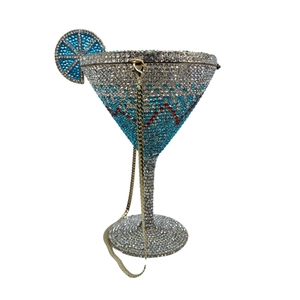 Detailed close-up of a martini glass shaped evening clutch with blue and red crystals