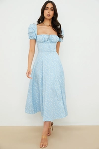 Close-up of the square neckline with drawstring detail and puff sleeves on floral maxi dress