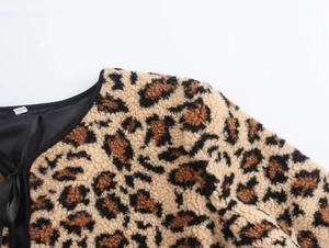 Close-up of leopard print fleece jacket collar with black trim and lace-up details