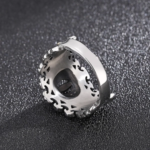 Retro crown punk style silver stainless steel ring with eye-shaped relief on black background