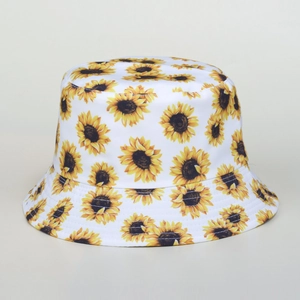 White bucket hat with yellow sunflower print featuring a flat top and sun protection