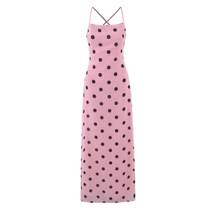 Pink polka dot maxi dress with spaghetti straps and open cross-back design on white background