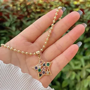 Detail of 18K gold-plated star pendant with colorful crystals on a stylish ball chain