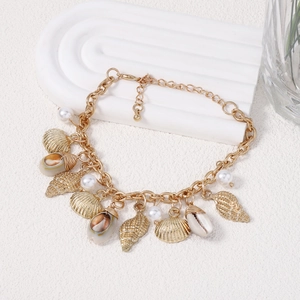 Vintage Baroque pearl and conch shell bracelet in gold finish with a bohemian seaside style