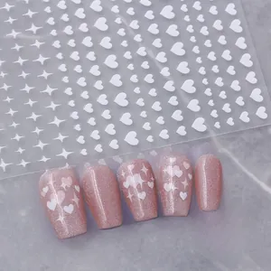 Detail of white heart and star nail stickers with pink glitter press-on nails display