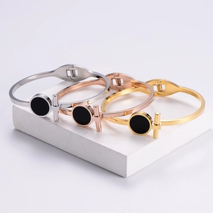 Minimalist T-shape titanium steel bangles in silver, rose gold, and gold on stone base