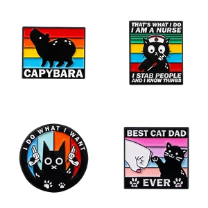 Set of four cartoon alloy enamel pins featuring funny black cats and a capybara design