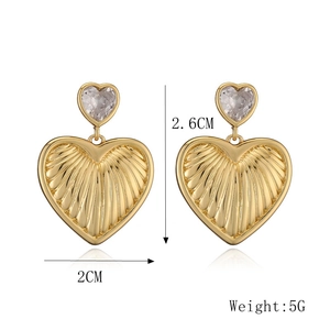Detail shot of heart earrings measuring 2.6cm by 2cm with gold textured finish