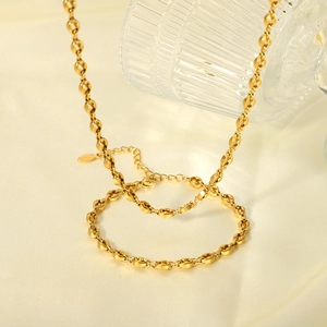 Polished 18K gold plated stainless steel coffee bean link necklace on silk fabric