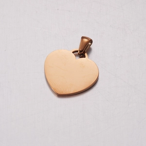 Polished rose gold heart-shaped stainless steel pendant with clasp on white surface