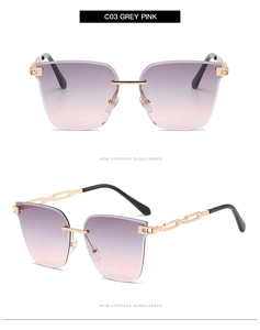 Detailed views of rimless gradient grey-pink lenses with gold metal temples on white background