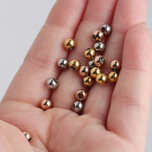 Close-up of 5mm stainless steel beads in gold, rose gold and silver for DIY jewelry