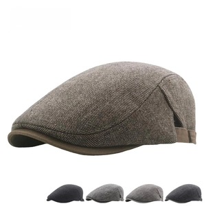 Close-up of herringbone tweed fabric texture on a classic British style flat cap