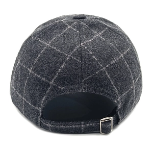 Detail view of the adjustable metal buckle and dark grey plaid wool texture on baseball cap