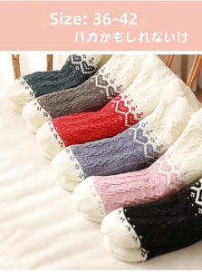 Detail view of 6 pairs of thick winter socks with snowflake patterns and fleece lining