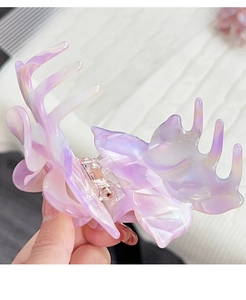 Macro shot of large purple-pink gradient acetate hair claw clip with holographic pearly finish