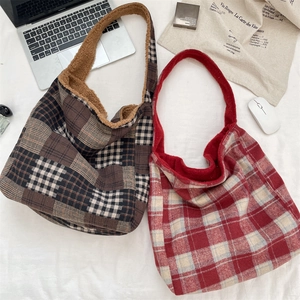 Close-up of brown and red plaid tote bags featuring soft plush fur trim for autumn and winter