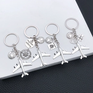 Travel keychain set with silver airplane, globe, and engraved compass charms