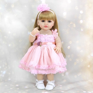Detailed full view of 55cm reborn doll wearing a pink lace dress and floral headpiece