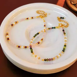 Elegant 18K gold plated bracelet with colorful gemstones and freshwater pearls in a dish