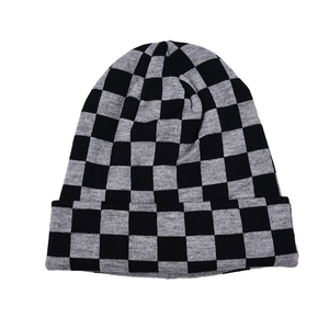 Close-up of checkerboard knit beanie showing black and grey woven texture details