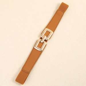Detail of tan elastic waist belt featuring a modern interlocking gold square metal buckle