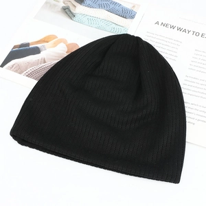 Detailed close-up of black ribbed knit beanie featuring premium texture and warmth
